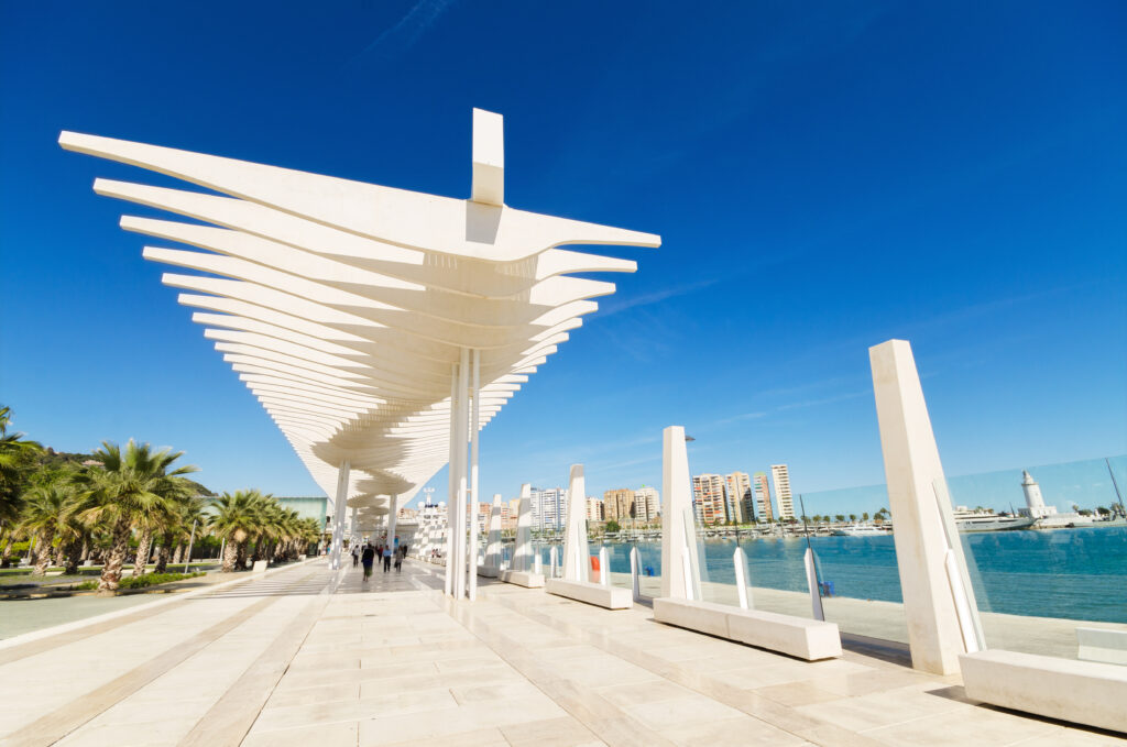 Palmeral de las Sorpresas en el puerto de Málaga con pérgola blanca y paseo junto al mar.